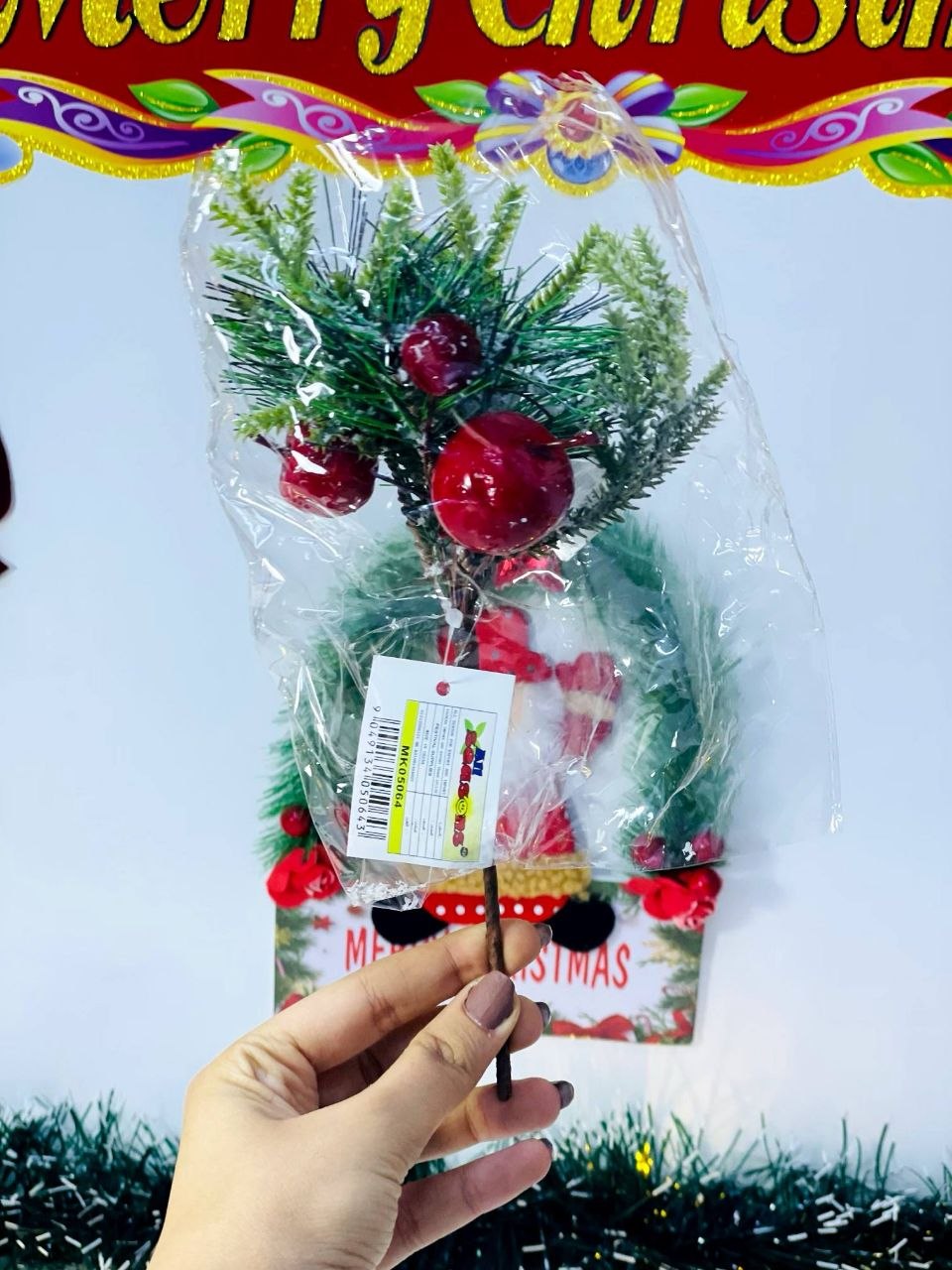 فرع زينة كريسماس بالثلج مزين بفواكه حمراء